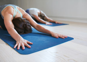 2 ladies doing pilates stretch