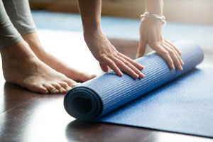 Woman doing online pilates session in Wrexham